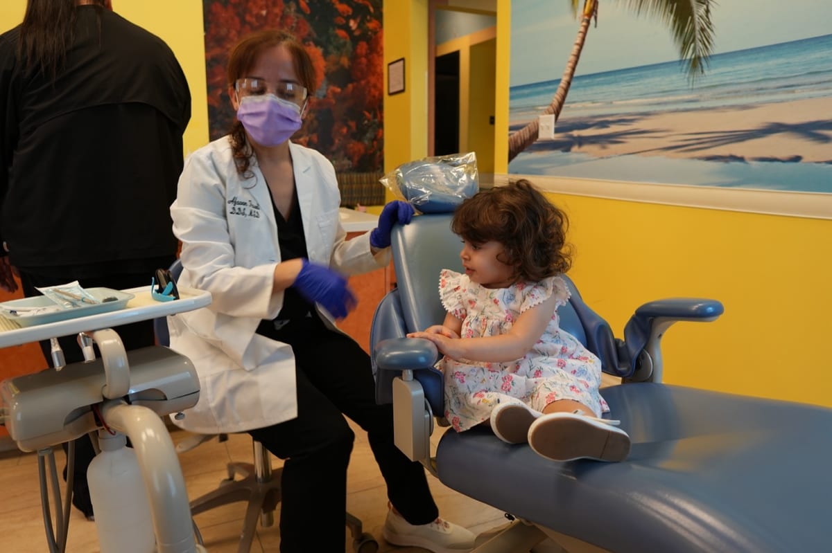 Dr. Fazeli caring for a young patient at Discovery Children's Dentistry